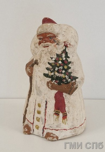 Игрушка елочная "Дед Мороз", несущий в правой руке елку, в левой - палку-посох.  Конец - 1930х годов